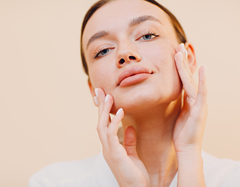 Young caucasian woman doing facebuilding yoga